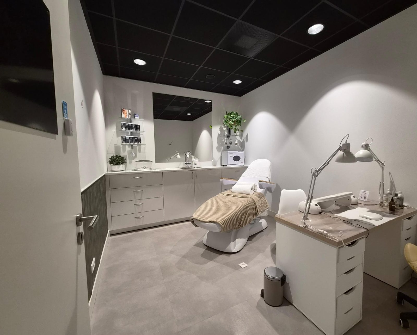 The treatment room at Marine Beauty Atelier: a bright, modern space with a treatment chair, manicure desk and soft lighting
